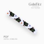 Loom bracelet pattern with repeating black cat faces, green eyes, pink details, and orange and purple accents.